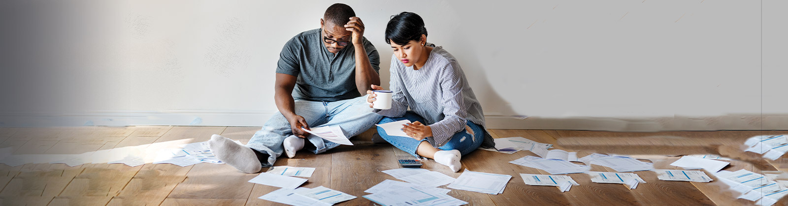 Couple on floor with bills 